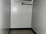 a small room with a white door and a tiled floor