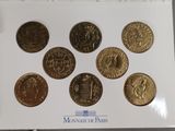 a close up of a box of coins on a table