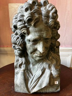 a close up of a bust of a man on a table