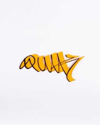 a yellow sticker with a word on it on a white surface