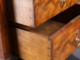 a close up of a wooden dresser with three drawers