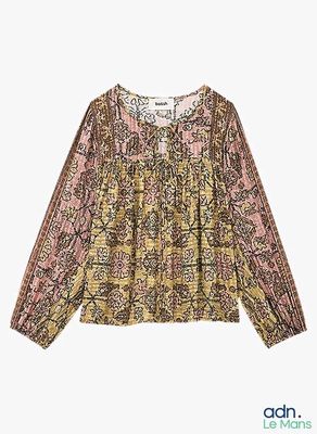 a women ' s blouse with a floral pattern and long sleeves