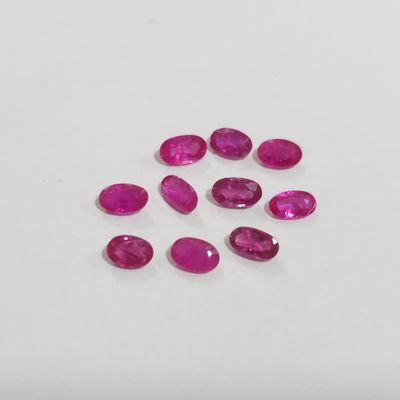a group of pink sapphires on a white surface
