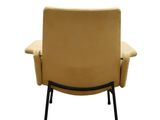 the back of a beige leather chair with black legs
