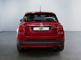 the back end of a red car with a license plate on it