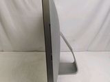 a computer monitor sitting on a stand on a white surface