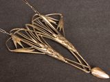 an image of a necklace made of silver metal and a pearl bead