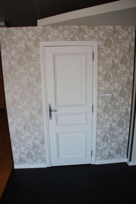 a white door and a black floor in a room