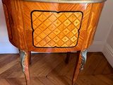 a small table with a wooden top on a hard wood floor