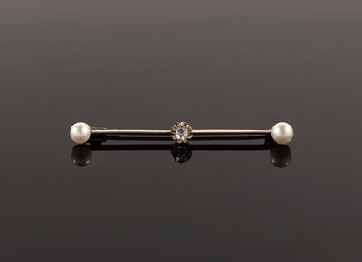 an image of a pearl nose piercing on a black surface