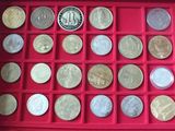 an assortment of silver and silver coins in a red box