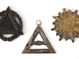 three metal items that include a triangle, a star, and a triangle