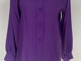 purple shirt on a mannequin stand with a white background