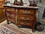 a large chest of drawers with a marble top