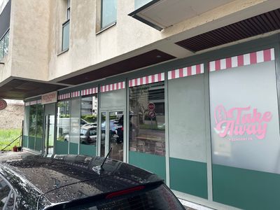 a car parked in front of a donut shop