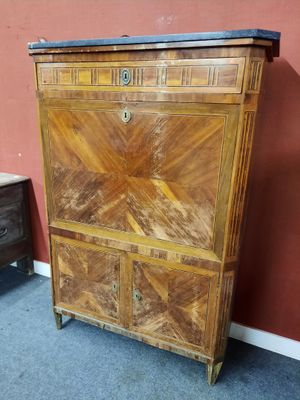 une armoire en bois avec un plateau en marbre, placée dans un coin de la pièce