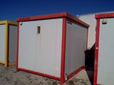 three portable toilets in a row in the desert