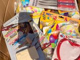 a cardboard box full of toys and supplies for a child