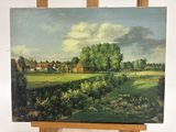 un tableau posé sur un chevalet représentant une ferme