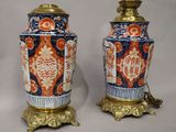 pair of antique chinese vases on stands on a white background