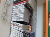 a lot of dvds stacked on a shelf in a room