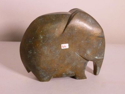 an elephant statue sitting on a table with a sticker on it ' s back