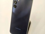a close up of a cell phone on a stand on a table