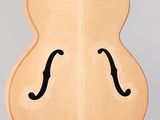 a guitar that is shaped like a face on the back of a guitar