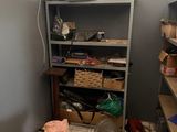 an image of a messy room with a shelf and a trash can