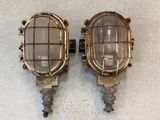 pair of antique brass wall sconces with caged lamps