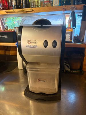 a coffee maker sitting on a counter in a restaurant