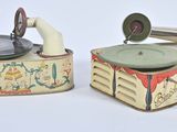 two old fashioned tins that are sitting on a table