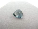 a close up of a blue diamond on a white surface