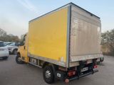 a yellow truck that is parked in a parking lot