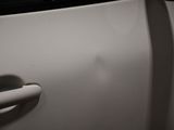 a close up of a door handle on a white car