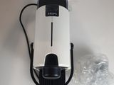 a white and black coffee machine on a white table