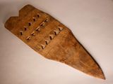 a wooden object that is on a white surface