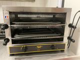 an image of a toaster oven with three trays of food in it