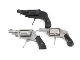 two revolvers are sitting side by side on a white surface