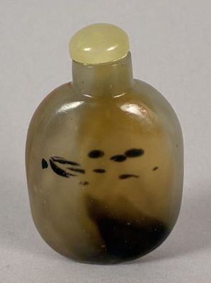 an image of a glass bottle with a cat face on it