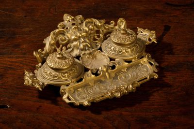 a lot of gold items sitting on a wooden table
