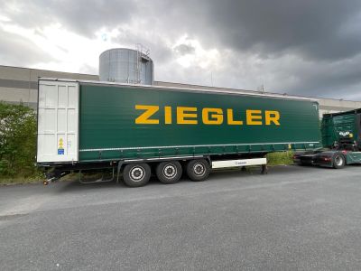a semi truck that is parked in front of a building