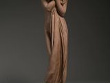 an image of a statue of a woman holding her hands to her face