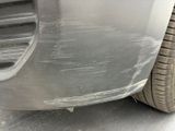 a close up of a car ' s front bumper with scratches on it