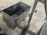 a small metal box sitting on the ground next to a pair of shoes