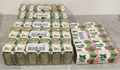 many bottles of juice sitting on the floor next to each other