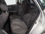 the back seats of a silver car with a black seat belt