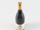 a bottle of wine sitting on top of a white table