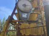 a large clock on the back of a yellow truck