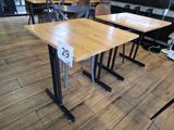 two tables with numbers on them in the middle of a room